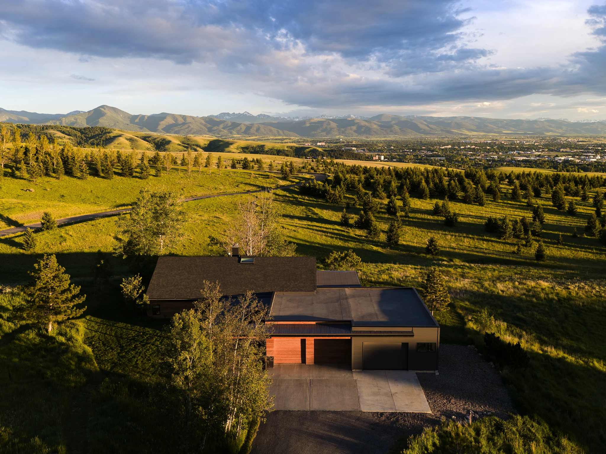 Aerial exterior view of the home overlooking the Gallatin Valley at golden hour — architectural photography Bozeman Montana, Living Places Design Studio